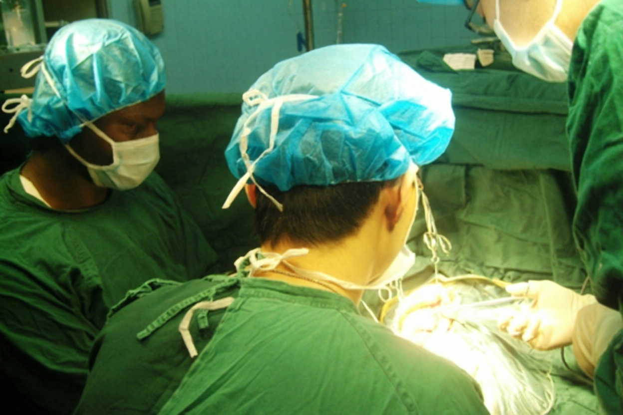 Medical professionals working in a surgical setting