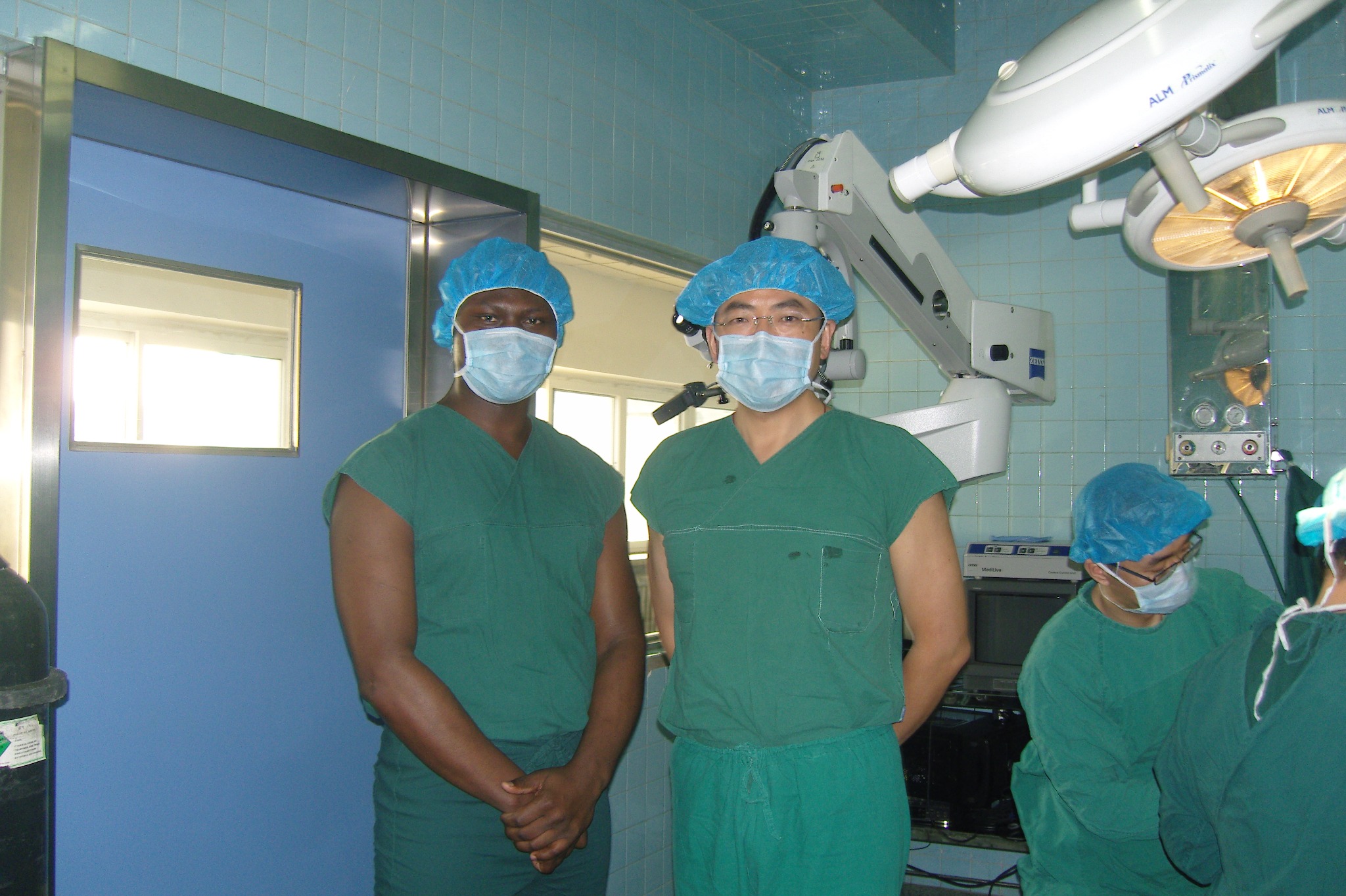 Masked clinicians in an operating room