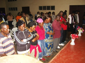 Community members standing together in an indoor gathering
